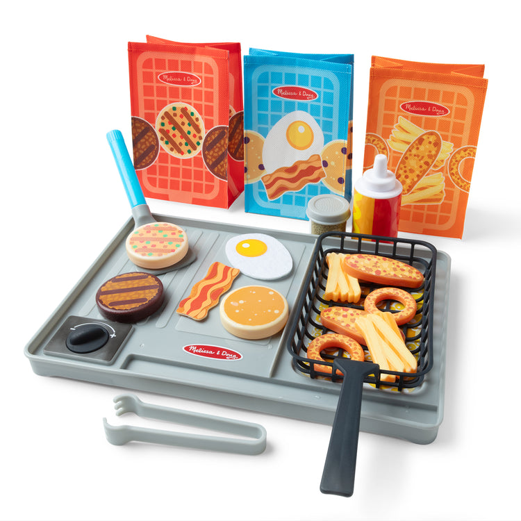 A playroom scene with The Melissa & Doug Flip & Fry Grill Play Set with Water WOW!® Color Changing Play Food Preschool Toy Ages 3+