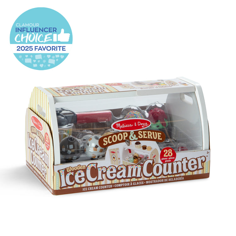 The front of the box for The Melissa & Doug Wooden Scoop and Serve Ice Cream Counter With Play Food and Accessories (28 Pcs) 