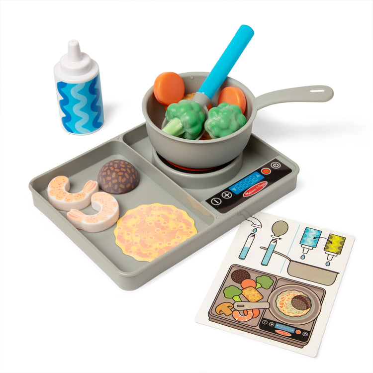 The loose pieces of The Melissa & Doug Simmer & Stir Stovetop Play Set with Water WOW!® Color Changing Play Food Preschool Toy Ages 3+