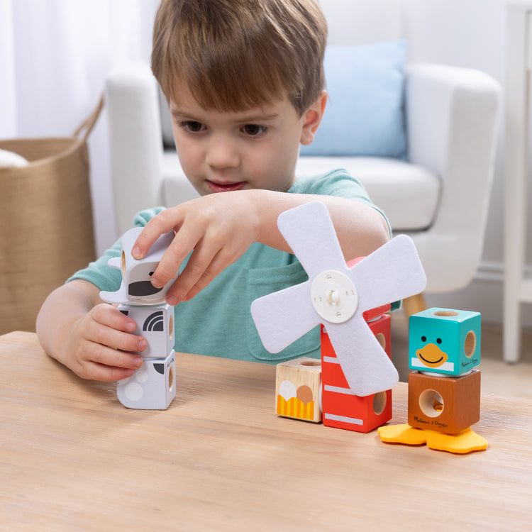 The front of the box for The Melissa & Doug Blockables™ Farm Friends Snap And Play, Mix And Match Connectable Wooden Building Blocks Play Set Toy for Preschool Boys And Girls (16 Pcs)